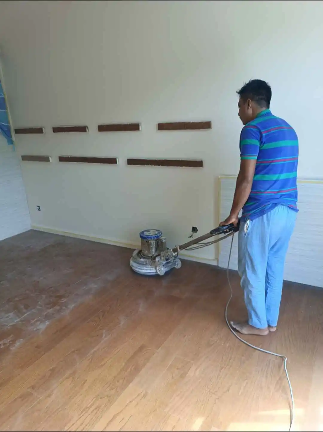 Polishing a timber floor with a rotary machine